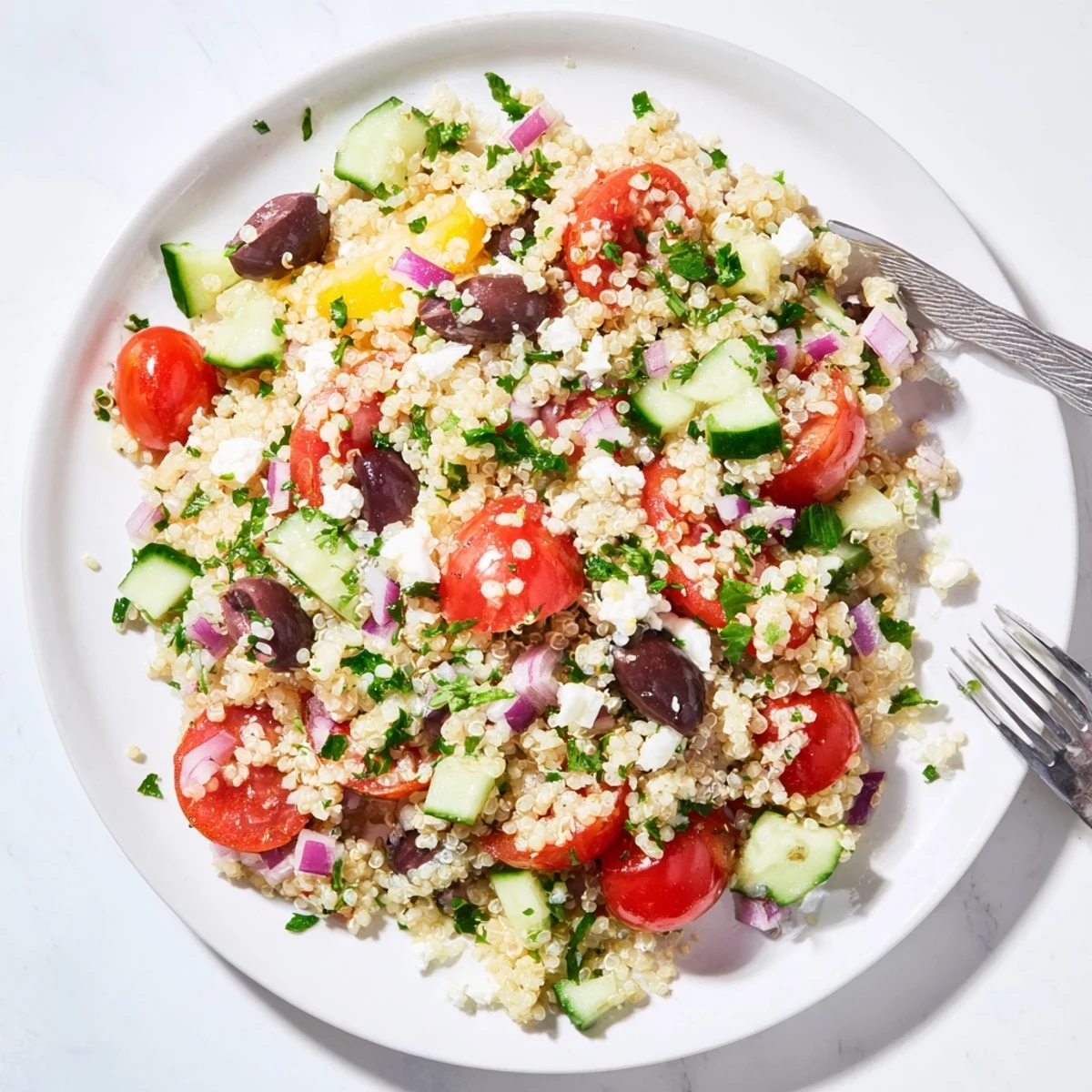 Overhead view of Mediterranean Quinoa Salad with Tomatoes, cucumbers, and olives.