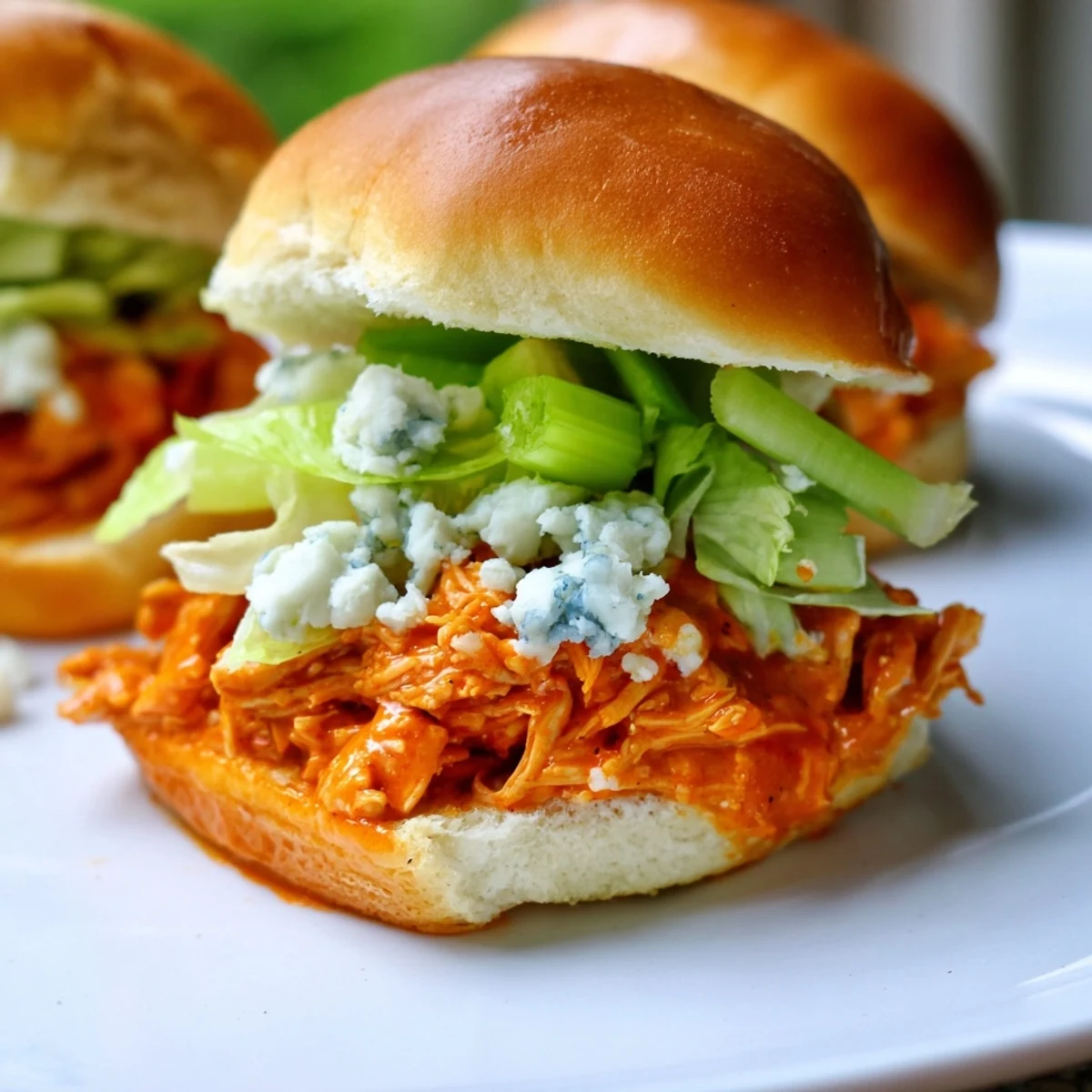 Crisp shredded lettuce and celery add a cool crunch to these spicy, tangy buffalo chicken sliders with blue cheese.
