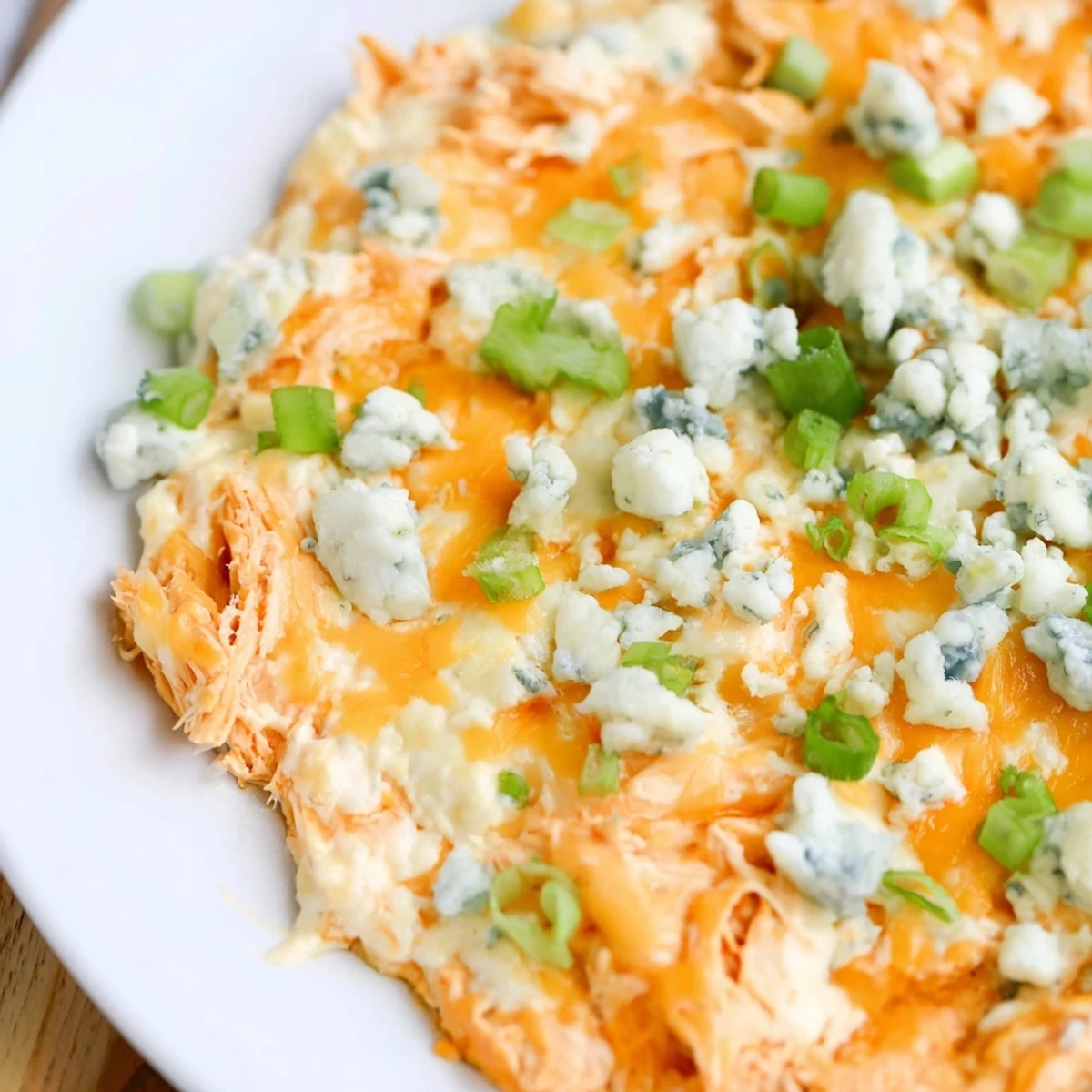 Golden Keto Buffalo Chicken Dip served with celery sticks and cucumber slices.