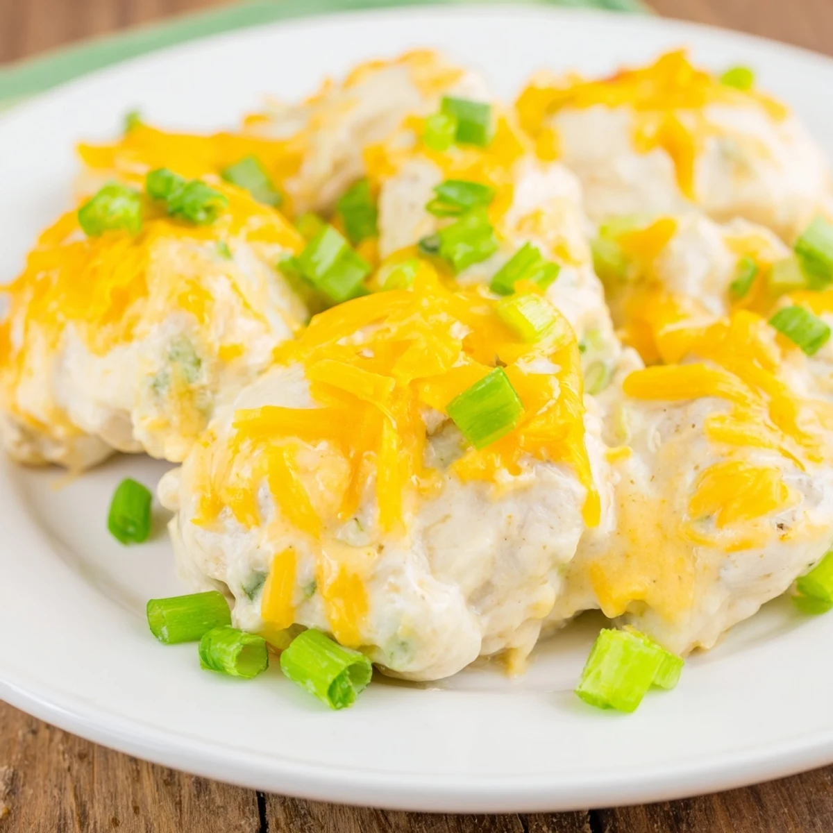 Juicy Sour Cream and Onion Chicken fresh from the oven, topped with bubbly cheddar and a side of steamed veggies.