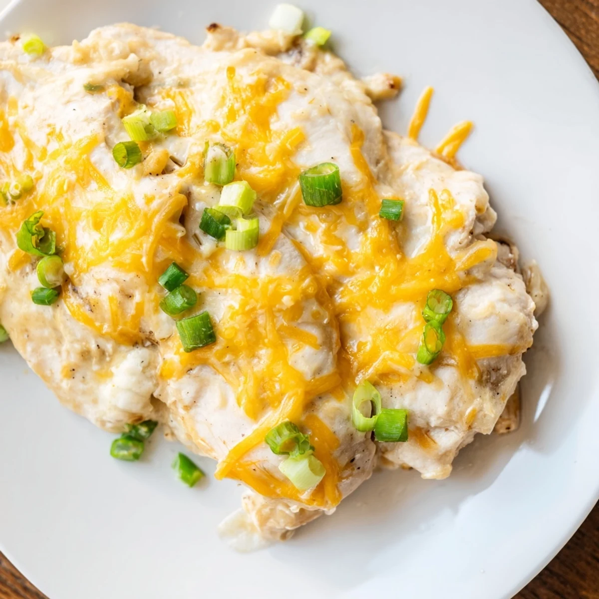 Golden-baked Sour Cream and Onion Chicken with a rich sauce, garnished with chopped green onions and ready to serve over rice.