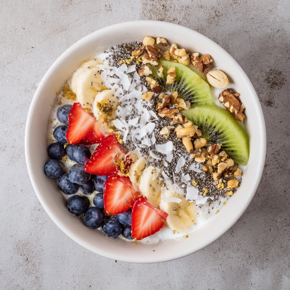 A close-up of a vibrant Healthy Breakfast Bowl with creamy yogurt, fresh strawberries, banana slices, and crunchy granola.
