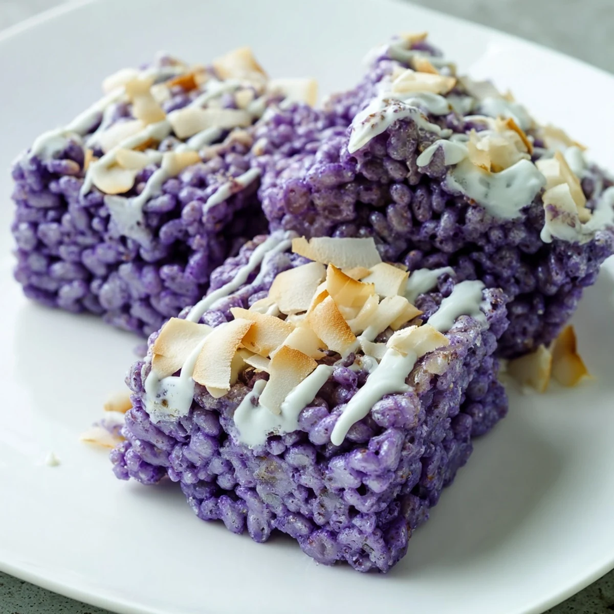 Chewy ube rice krispie treats squares with creamy marshmallow coating and vibrant purple color