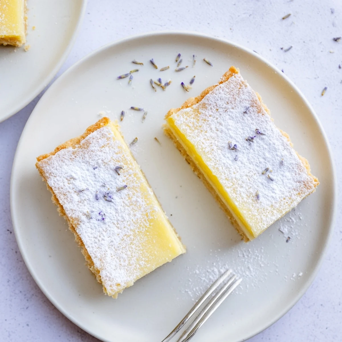 Teatime dessert featuring aromatic lavender lemon cream bars with snowy powdered sugar topping