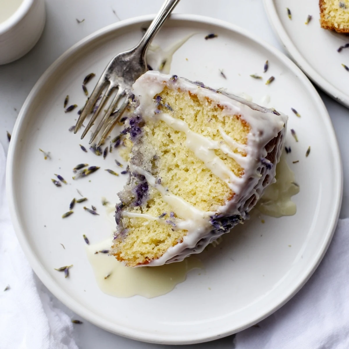 Freshly baked lemon lavender cake with zesty glaze on a wooden cutting board ready for spring dessert