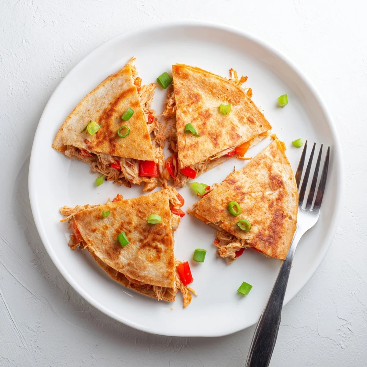 Golden baked chicken and cheese quesadillas with melted cheese and spicy seasoned chicken