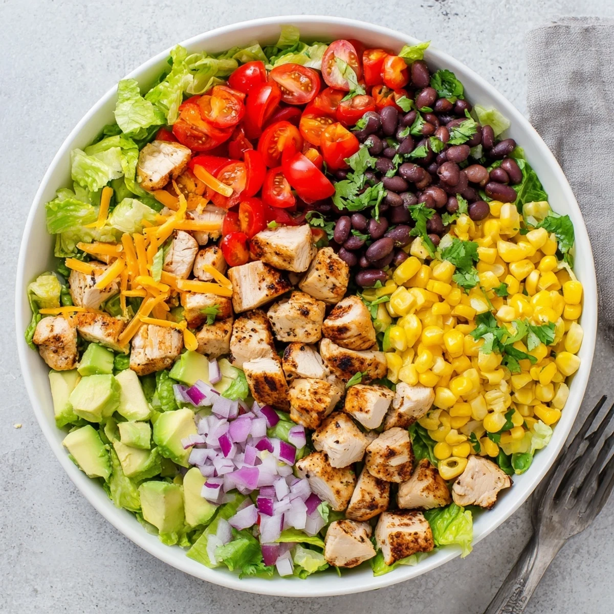 Colorful Healthy BBQ Chicken Chopped Salad bowl with grilled chicken, fresh vegetables, and creamy dressing