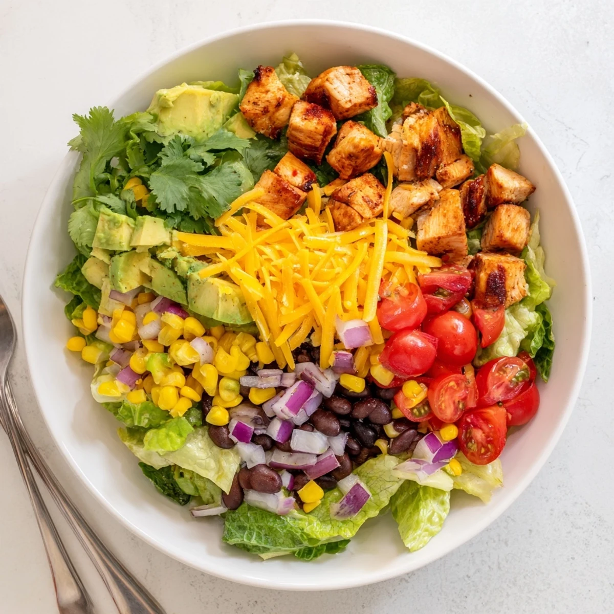 Protein-packed Healthy BBQ Chicken Chopped Salad featuring tender grilled chicken over crisp romaine lettuce and colorful veggies