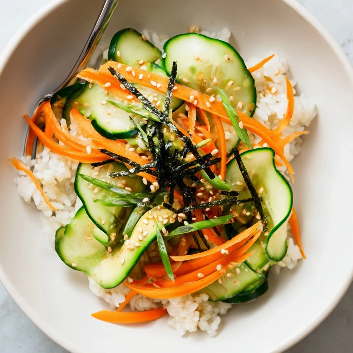 Sushi Cucumber Salad with crisp cucumber ribbons, avocado slices, nori garnish