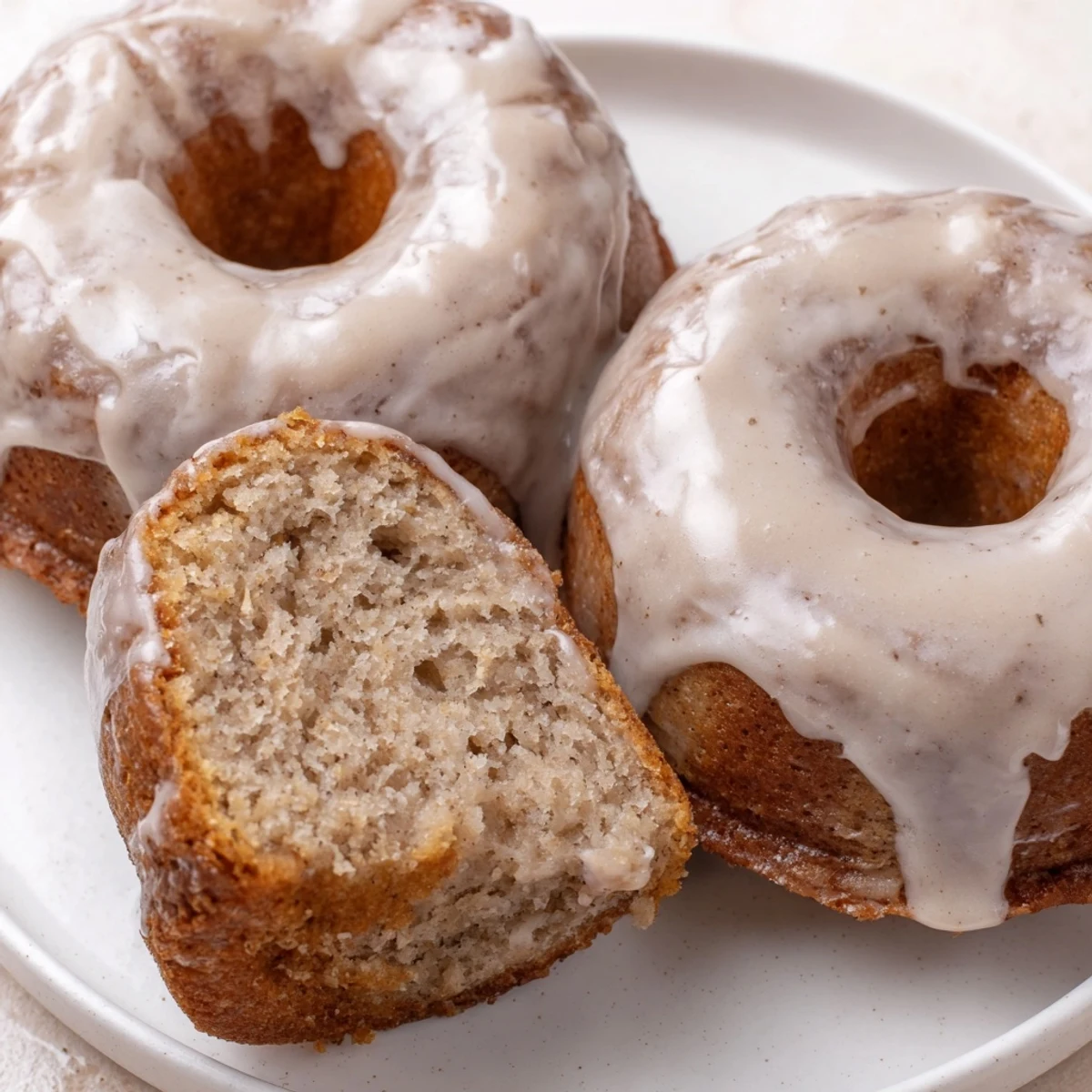 Homestyle Banana Donuts sliced open to show fluffy, cake-like interior and steam