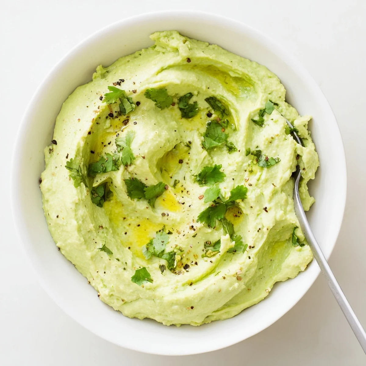 Toasted bread topped with Creamy Avocado Feta Dip, lime zest and cilantro