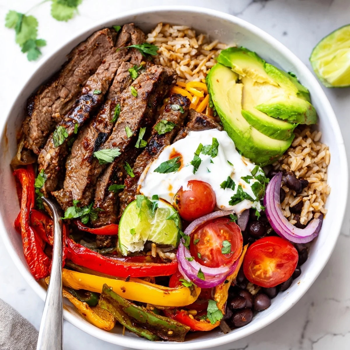 Steak Fajita Power Bowls served over warm brown rice, creamy avocado, lime.