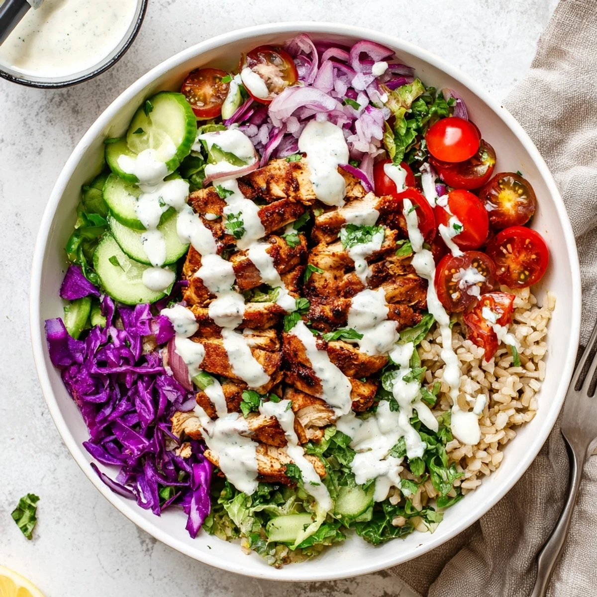 Close-up of nutritious healthy chicken shawarma bowl featuring tender spiced chicken, crunchy red cabbage, cucumbers, and tangy yogurt sauce