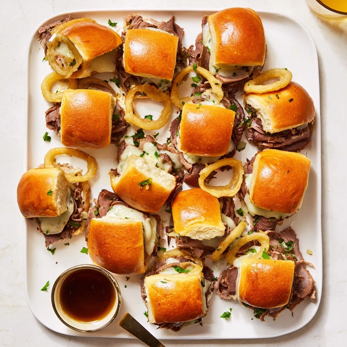 Golden melted provolone covers tender roast beef on these savory French dip sliders