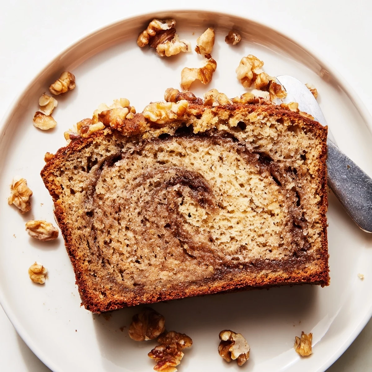 Freshly baked banana nut bread with chopped walnuts and ribbons of cinnamon sugar