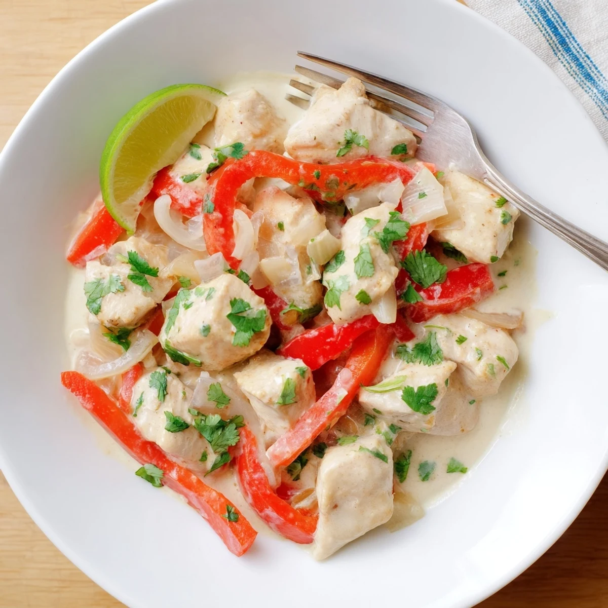 Creamy Brazilian coconut chicken with tender pieces swimming in rich white coconut sauce
