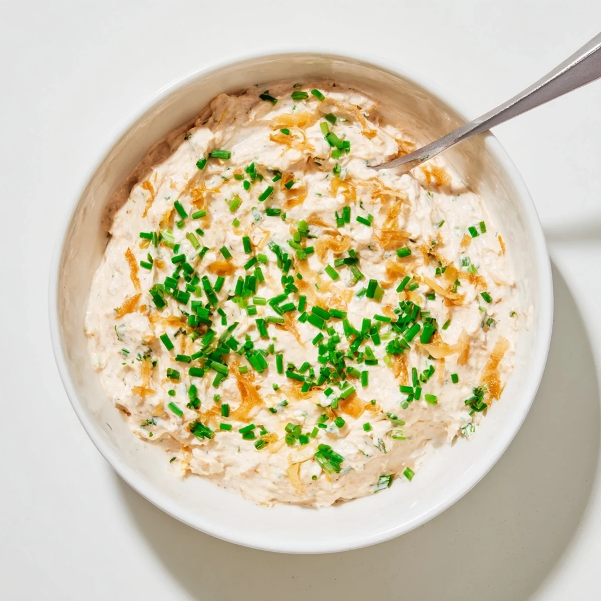 Homemade French onion dip with deeply browned sweet onions folded into smooth sour cream and mayonnaise base
