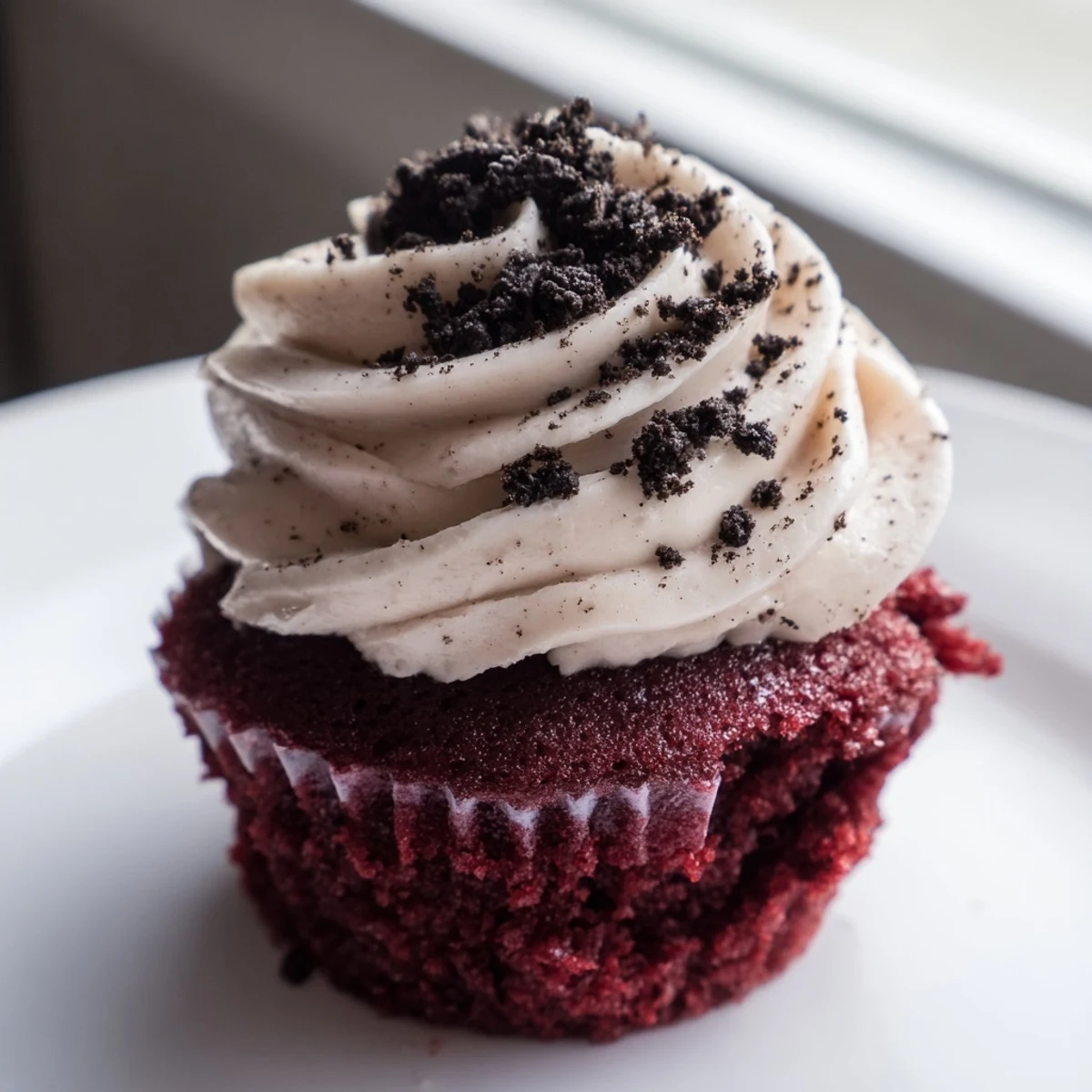 Soft Red Velvet Oreo Cupcakes with tangy cream cheese swirl and chocolate cookie crumbles