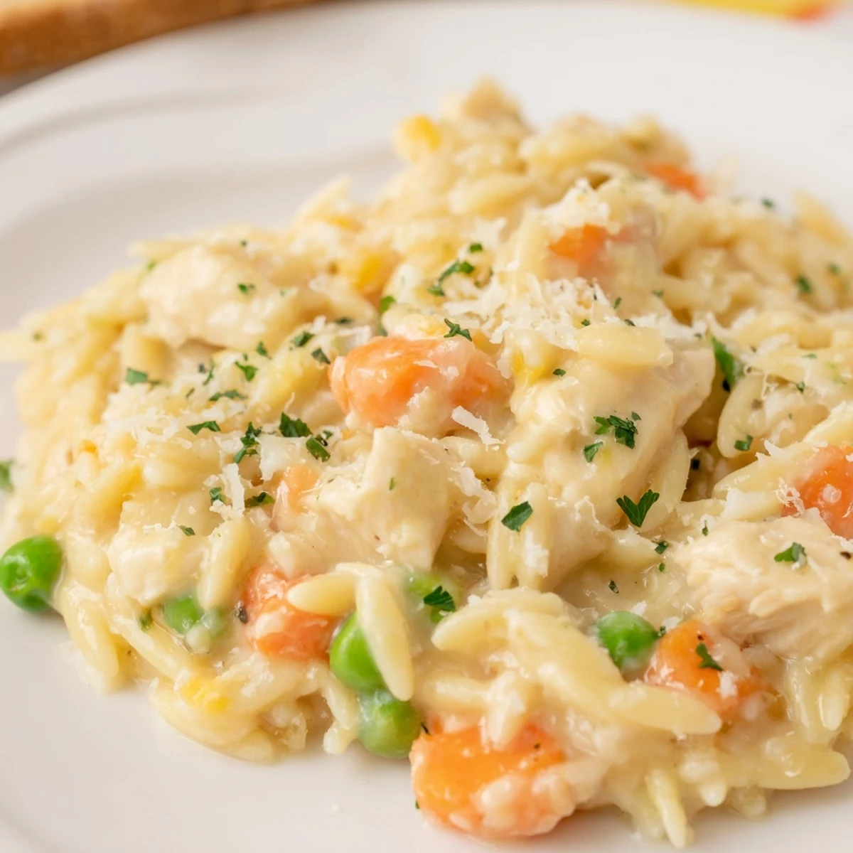Golden tender chicken and vibrant vegetables swimming in a rich creamy chicken pot pie orzo