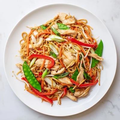 This plated Chicken Chow Mein features stir-fried noodles, colorful veggies, and scallions, ready for a quick and satisfying weeknight dinner.