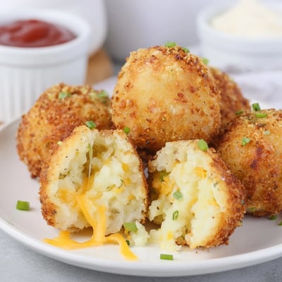 Close-up of Fried Mashed Potato Balls revealing cheesy, steaming, pillowy centers