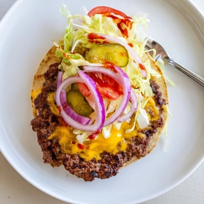 Griddled Smash Burger Tacos topped with shredded lettuce, pickles, and sauce